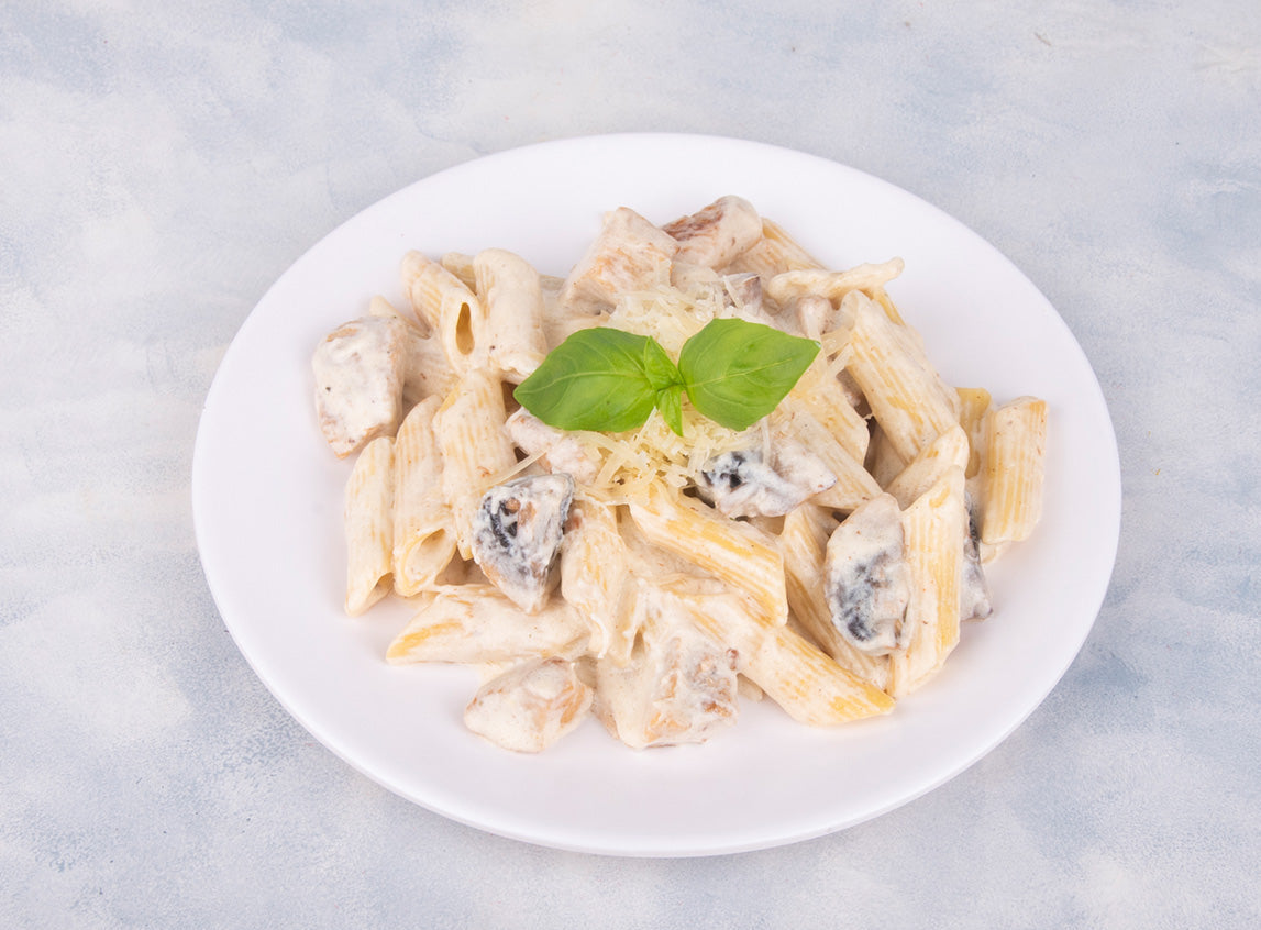 Delicious creamy pasta with rich white sauce from Heeran Al Dar Cafeteria, featuring pasta and white sauce with a hint of garlic and herbs.