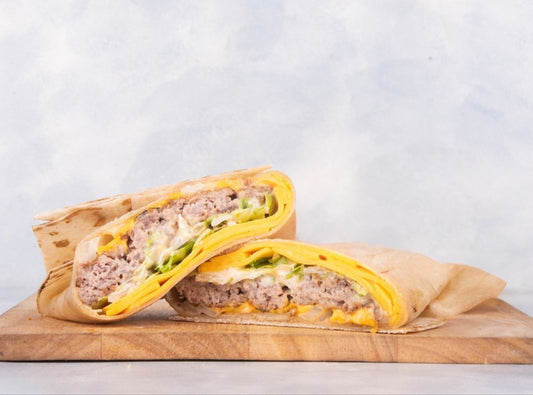 A Juicy Heraan Wrap from Heraan Al Dar Cafeteria, featuring grilled sirloin steak, fresh vegetables, and special house sauce wrapped in soft flatbread. Fresh, Heraan, Wrap.