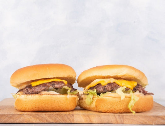 Mini Heraan Slider from Heraan Al Dar Cafeteria featuring two grilled sliders with fresh lettuce, tomato, cheese, and special sauce in soft buns, perfect for burger lovers.