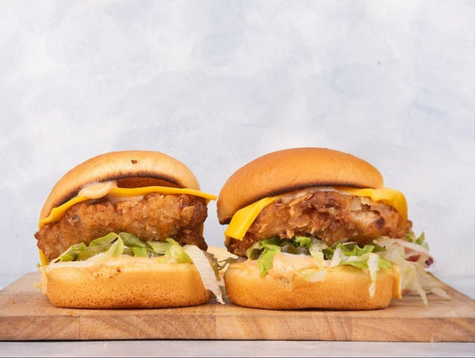 Delicious mini chicken sliders from Heraan Al Dar Cafeteria, featuring grilled chicken, fresh lettuce, and tomatoes, perfect for snacking or appetizers.